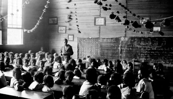 Judia Jackson Harris remained as principal of her school from its founding in 1903 until her retirement in 1949, though the school’s name changed from the Model & Training School to the Clarke County Training School, and eventually to the Judia C. Jackson Harris School. In this 1921 photo by Jackson Davis, we see one of Jackson Harris’s teachers with some of the school’s many pupils.